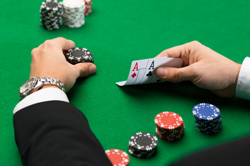 poker player with cards and chips at casino