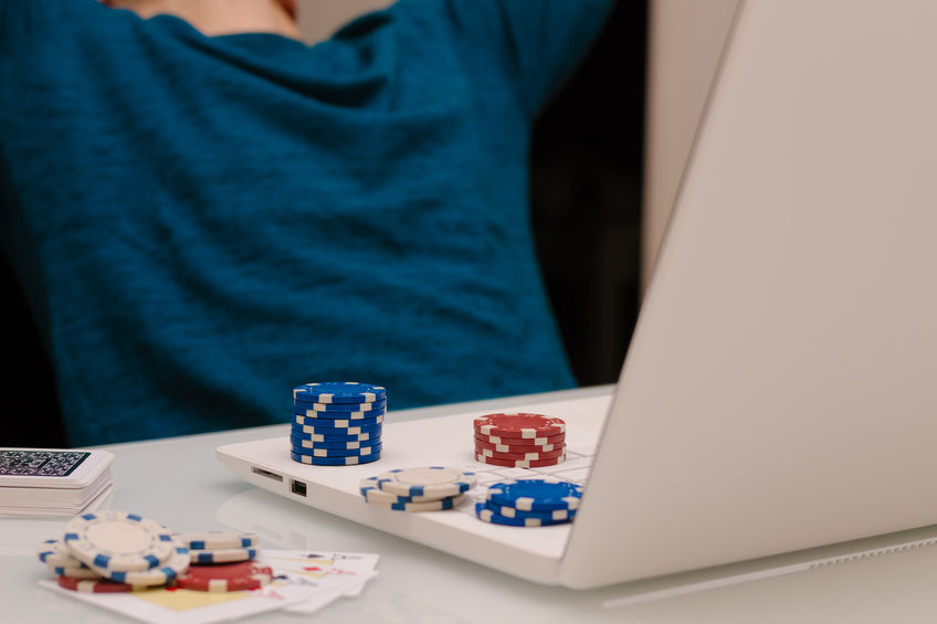 gamer man playing with his laptop from home to casino games, poker, blackjack, roulette. concept of online gambling, win money, sports bet, chance, succeed, fortune, addiction